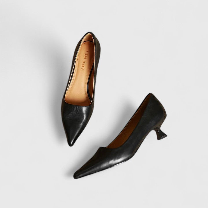 A woman in classic black pointed-toe comfort heels moving easily from office to evening.