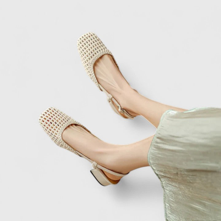 Soft green bow-detail mules with a slim T-strap, open back and a low heel.