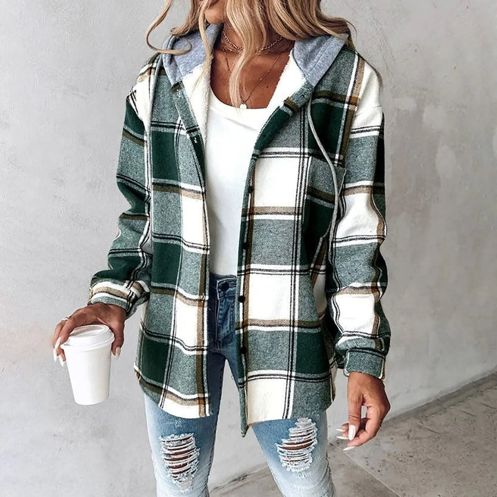 A woman wearing a grey and white checked hooded jacket with a button front