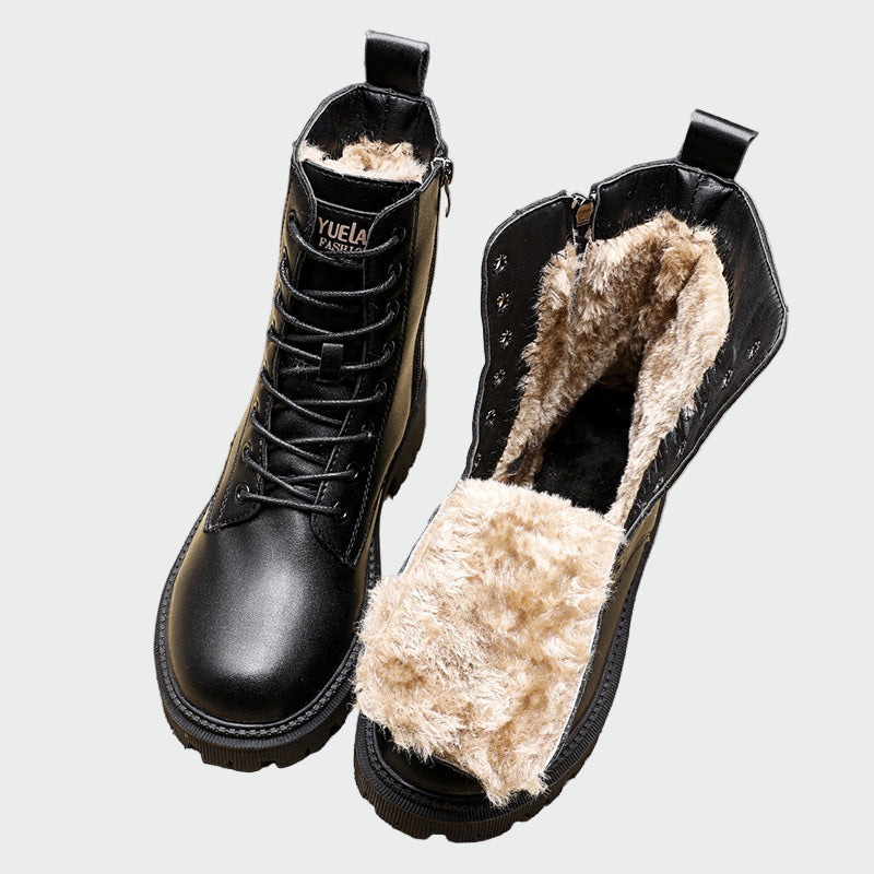A woman stepping out on a cold day in sleek black ankle boots with a side zip.