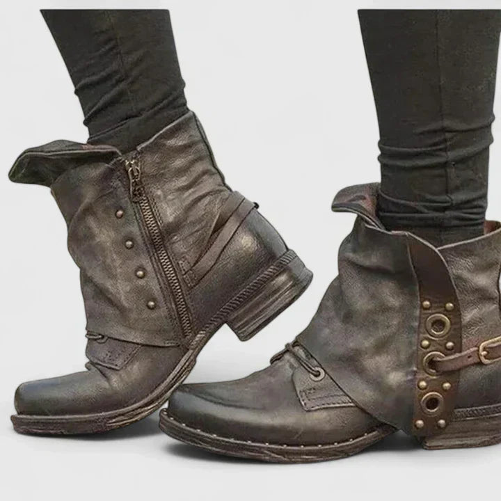 Woman wearing grey supportive ankle boots, walking confidently through town.