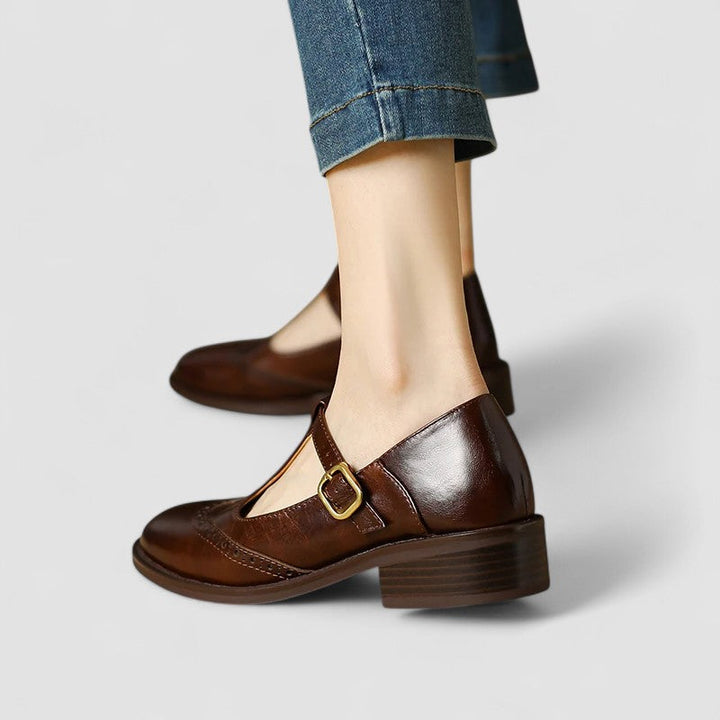 A woman in beige T-strap Mary Jane shoes, comfortable and balanced on a busy day.