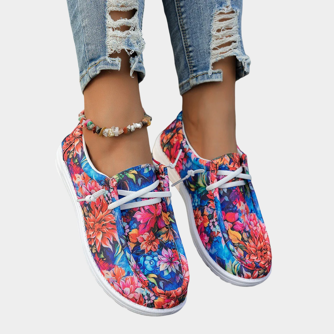 A woman wearing floral-print lace-up comfort shoes on a bright day out.