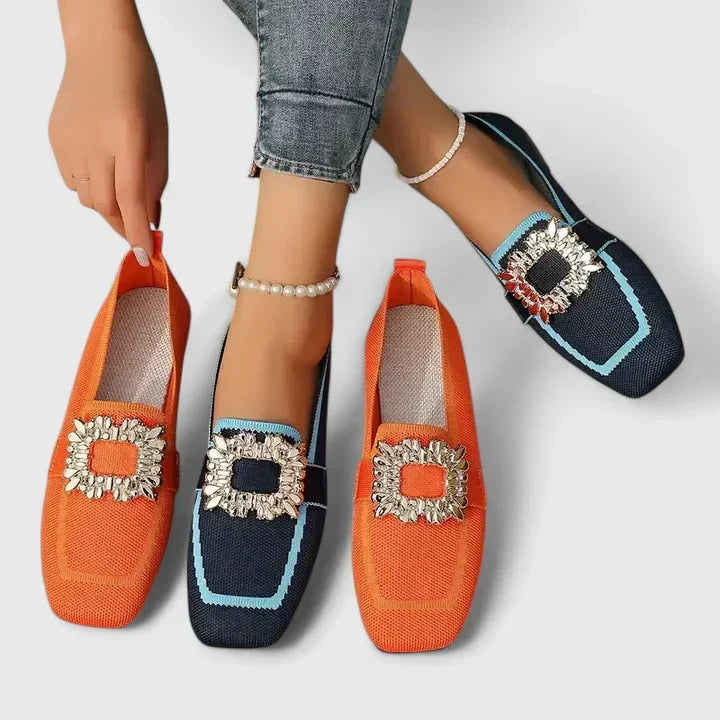 A woman wearing embellished comfort flats with a sparkling jewelled square buckle