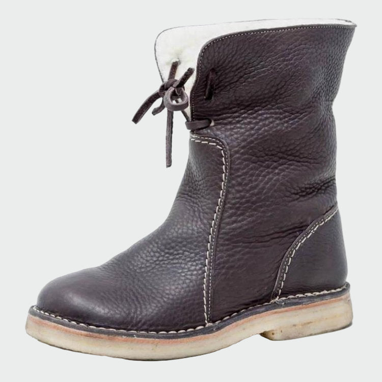 Woman wearing beige warm-lined winter boots on a cold day out.