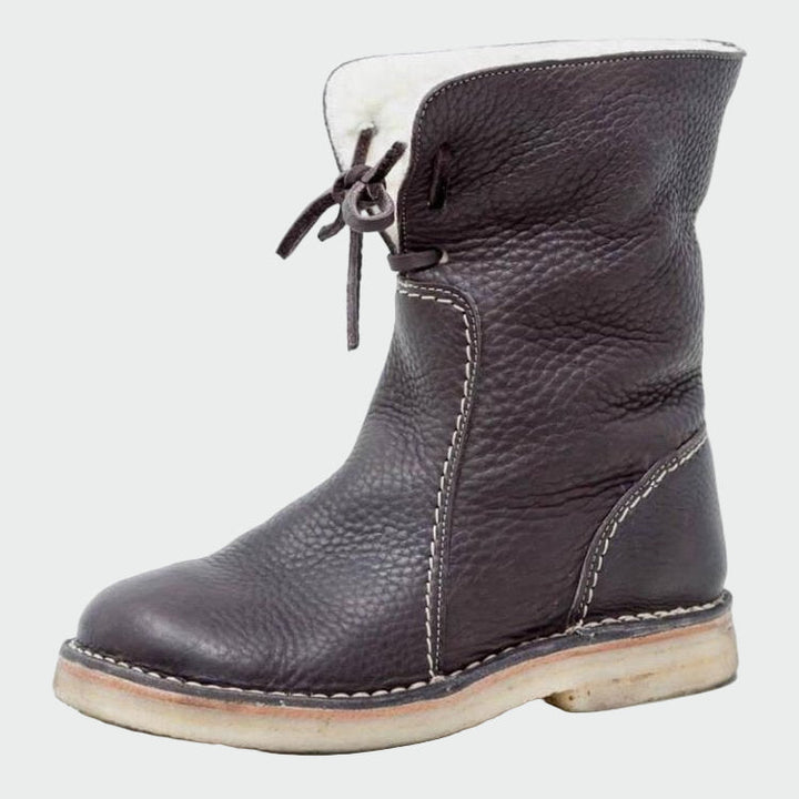 Woman wearing beige warm-lined winter boots on a cold day out.