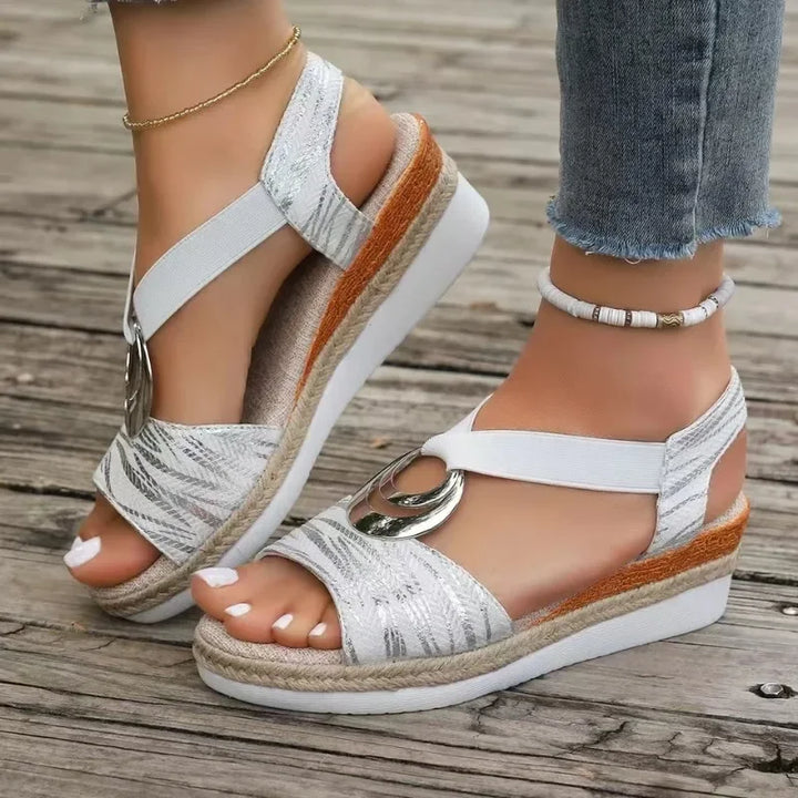 A woman moving with ease in supportive everyday sandals with an adjustable strap.