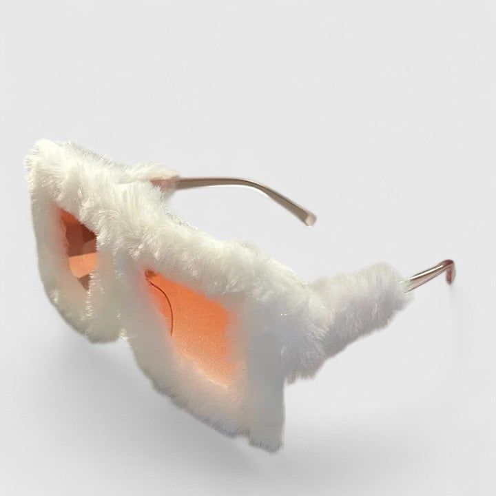 A bold pair of sunglasses with a soft red fluffy trim around the frame and slim black arms.