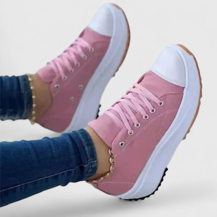 A woman in bold lace-up platform comfort sneakers styled with jeans.
