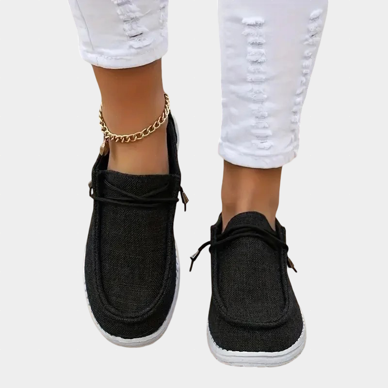 A woman wearing black lace-up comfort shoes while out and about.