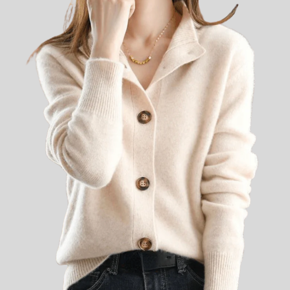 A woman wearing a beige retro button cardigan layered over a dress, warm and elegant.