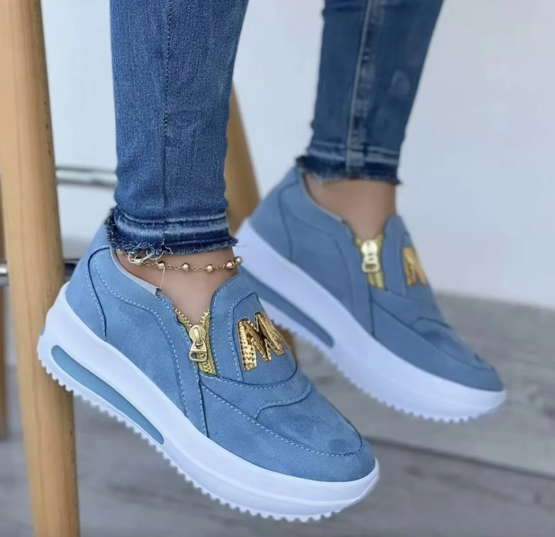 A woman wearing cushioned side-zip sneakers with a relaxed everyday outfit