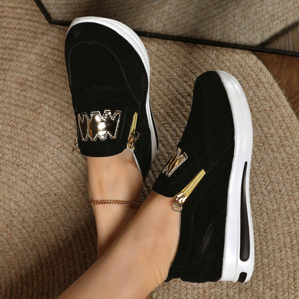 A woman wearing cushioned side-zip sneakers with a relaxed everyday outfit