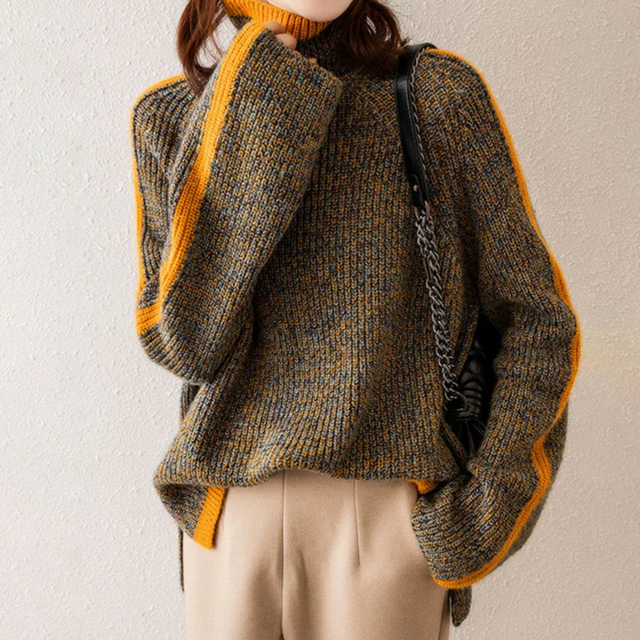 A woman wearing a softly textured everyday sweater with a relaxed modern line.
