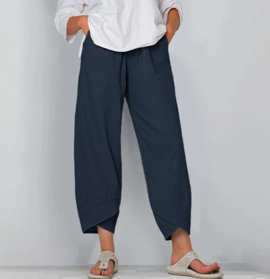 A woman wearing lightweight plain pants with an elastic waist and handy pockets.