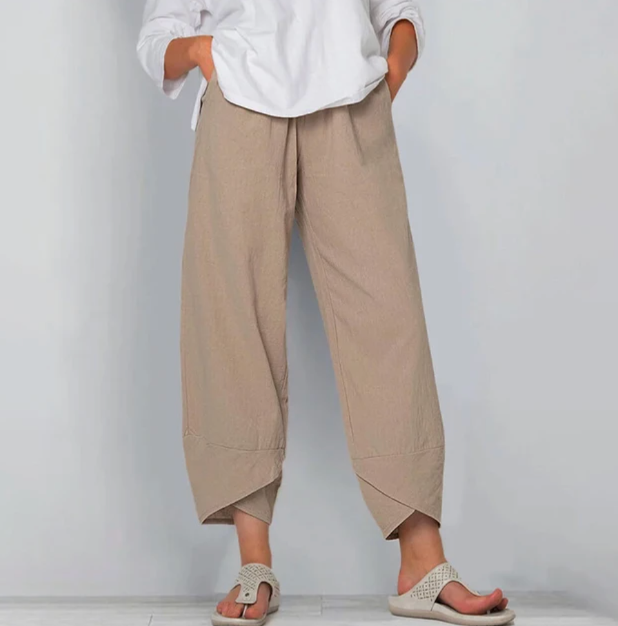 A woman wearing lightweight plain pants with an elastic waist and handy pockets.