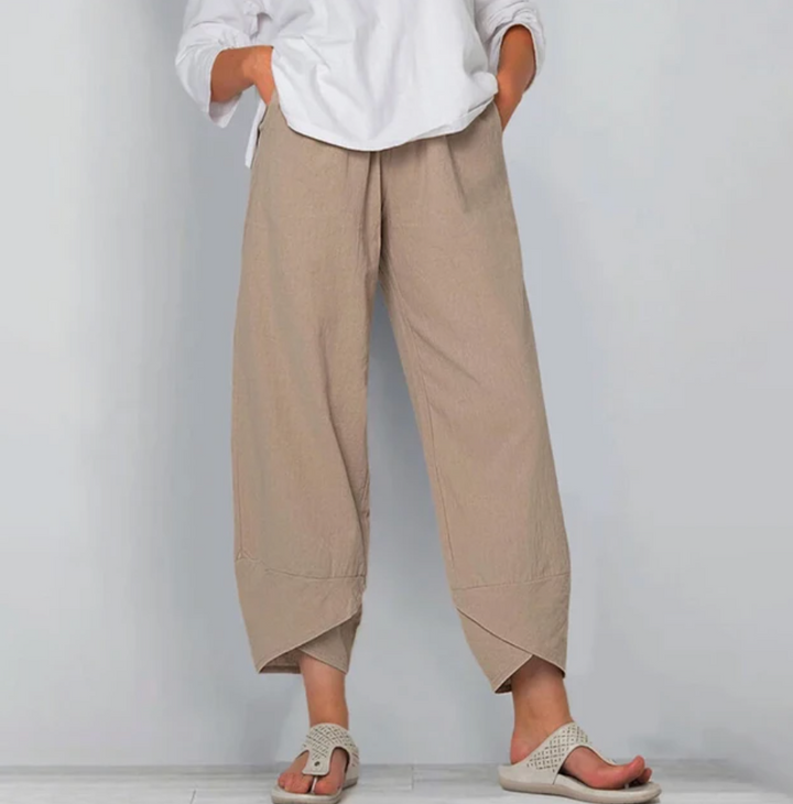 A woman wearing lightweight plain pants with an elastic waist and handy pockets.