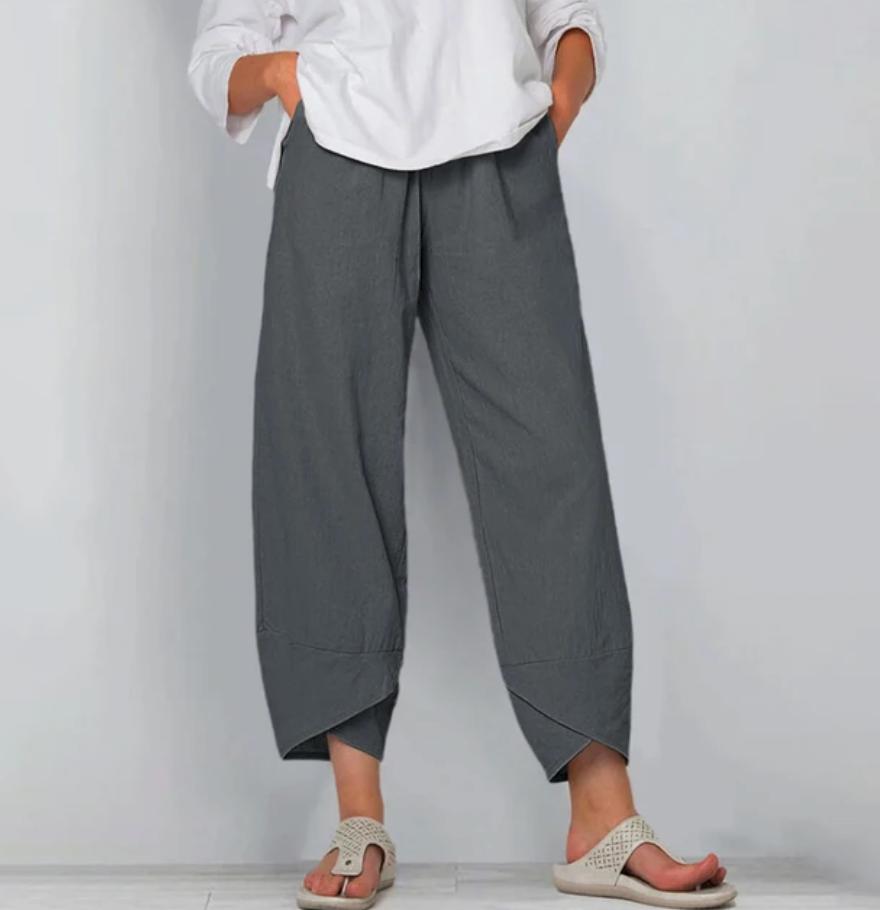 A woman wearing lightweight plain pants with an elastic waist and handy pockets.