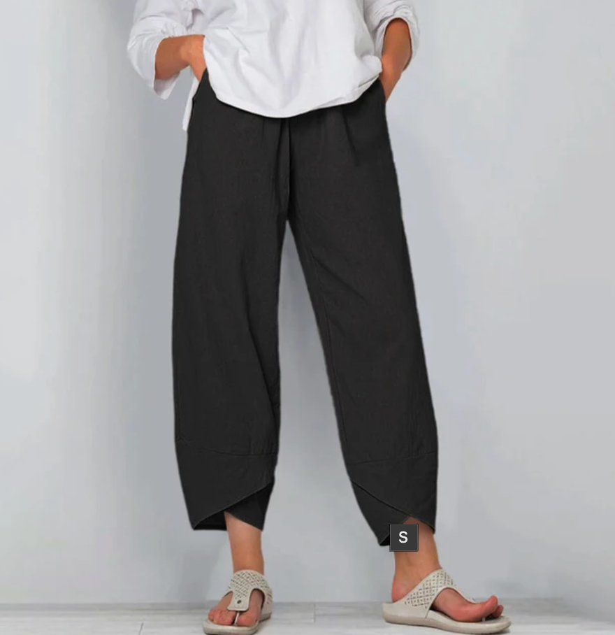 A woman wearing lightweight plain pants with an elastic waist and handy pockets.
