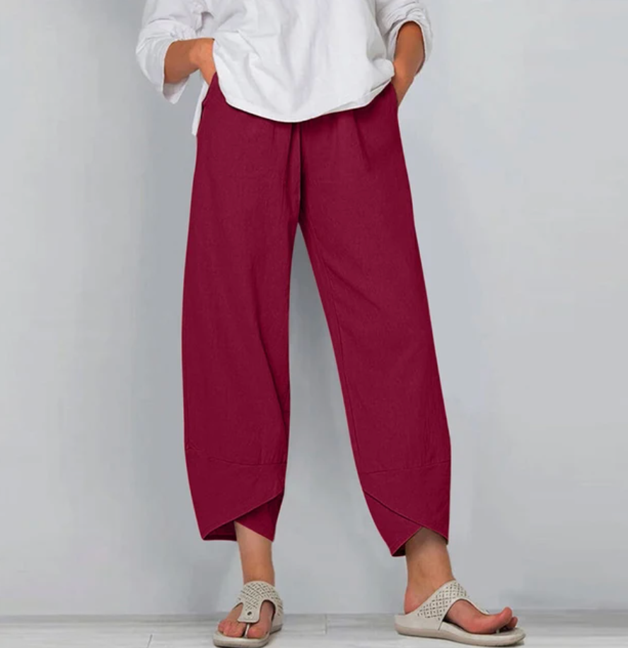 A woman wearing lightweight plain pants with an elastic waist and handy pockets.