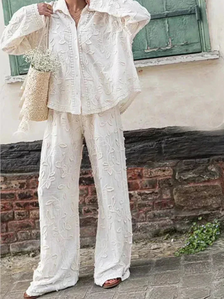 A woman wearing an embroidered relaxed two-piece set with wide pants