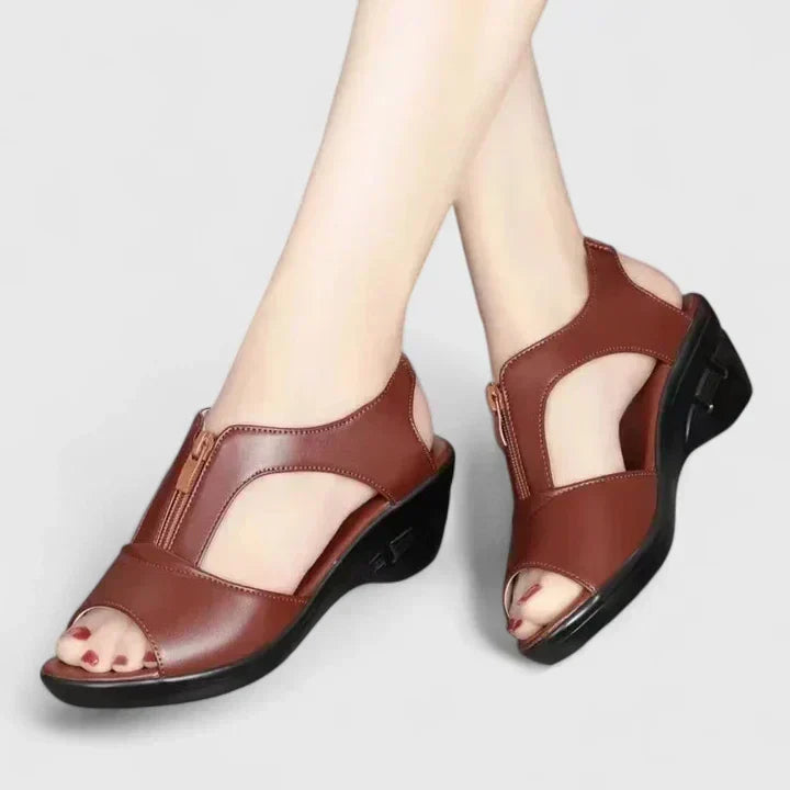Black peep-toe sandals with a buckled instep strap and a sturdy block heel.