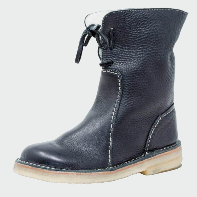 Woman wearing beige warm-lined winter boots on a cold day out.