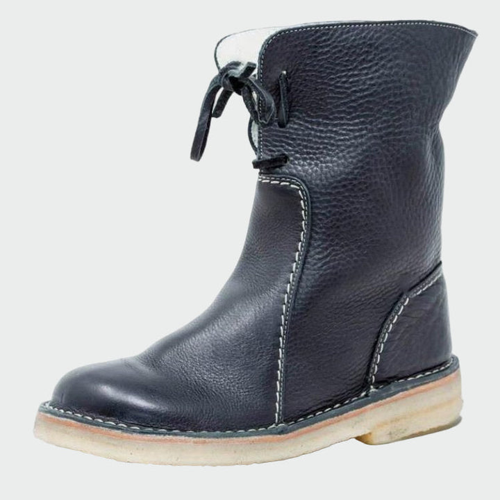 Woman wearing beige warm-lined winter boots on a cold day out.