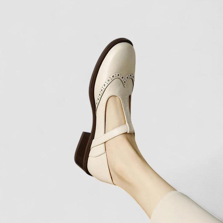 A woman in beige T-strap Mary Jane shoes, comfortable and balanced on a busy day.