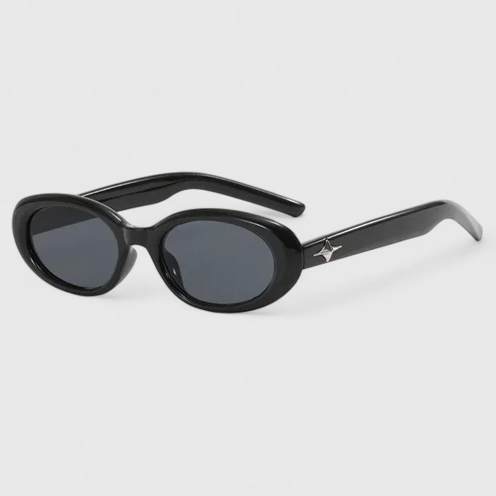 A woman in the city wearing chic oval sunglasses, confident and stylish in the sun.