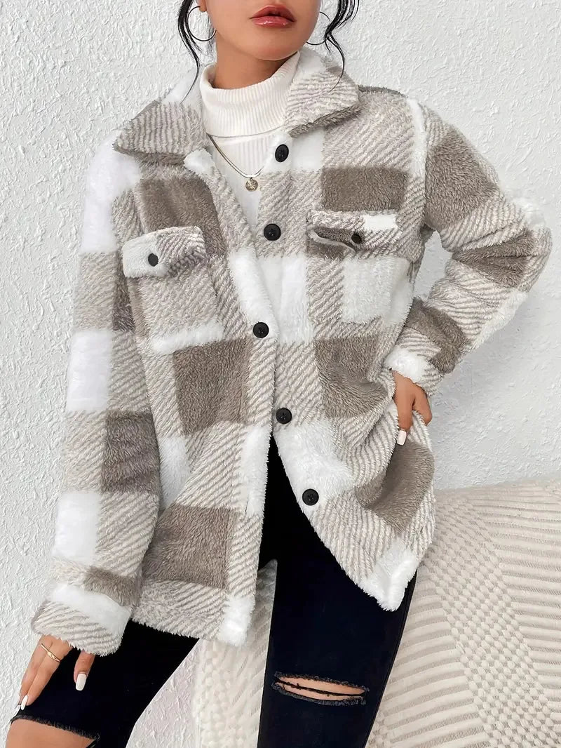 A woman wearing a soft checked jacket over casual clothes on a cool fall morning.