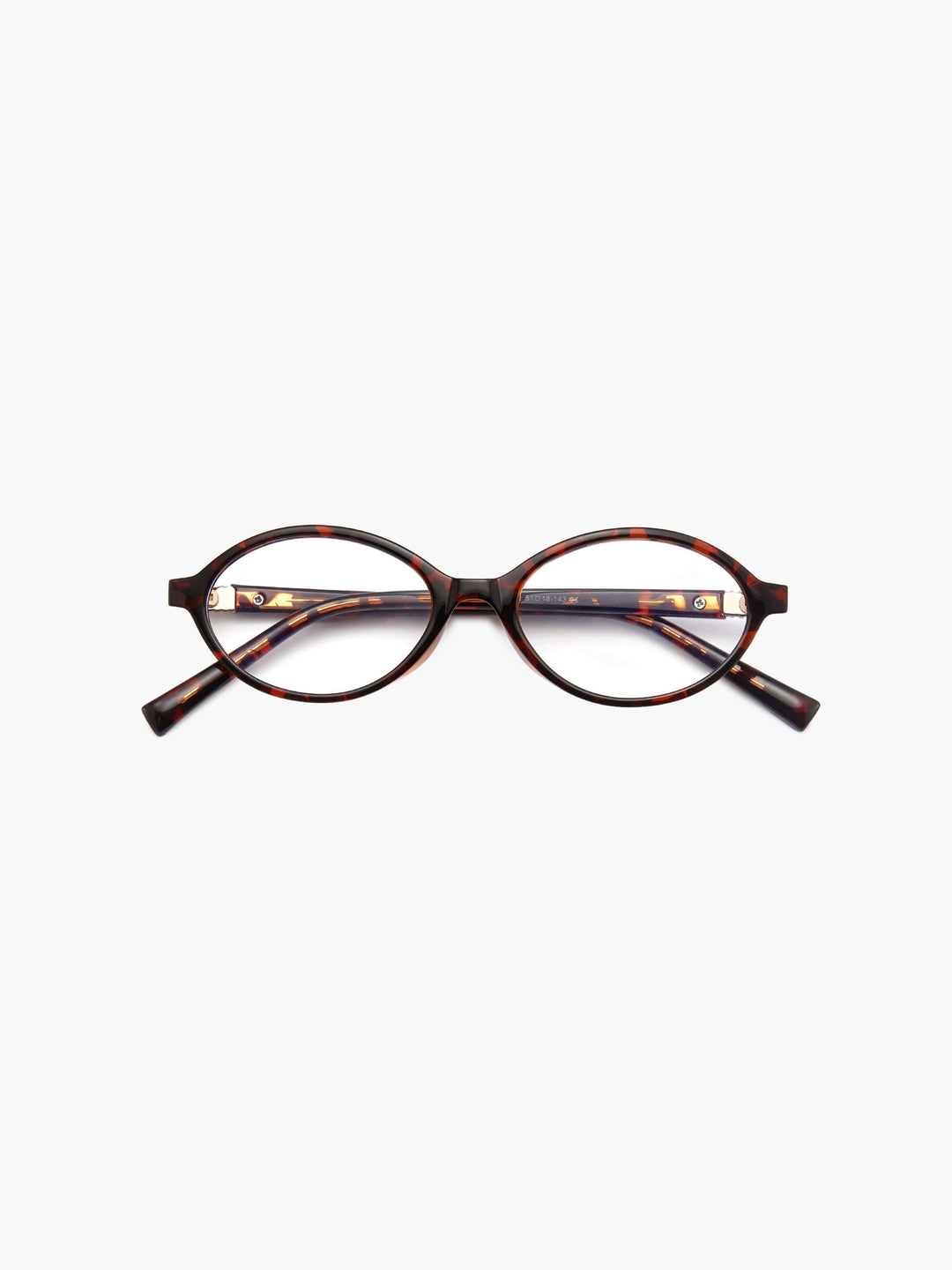 A woman wearing minimalist blue-light reading glasses while relaxing at home.