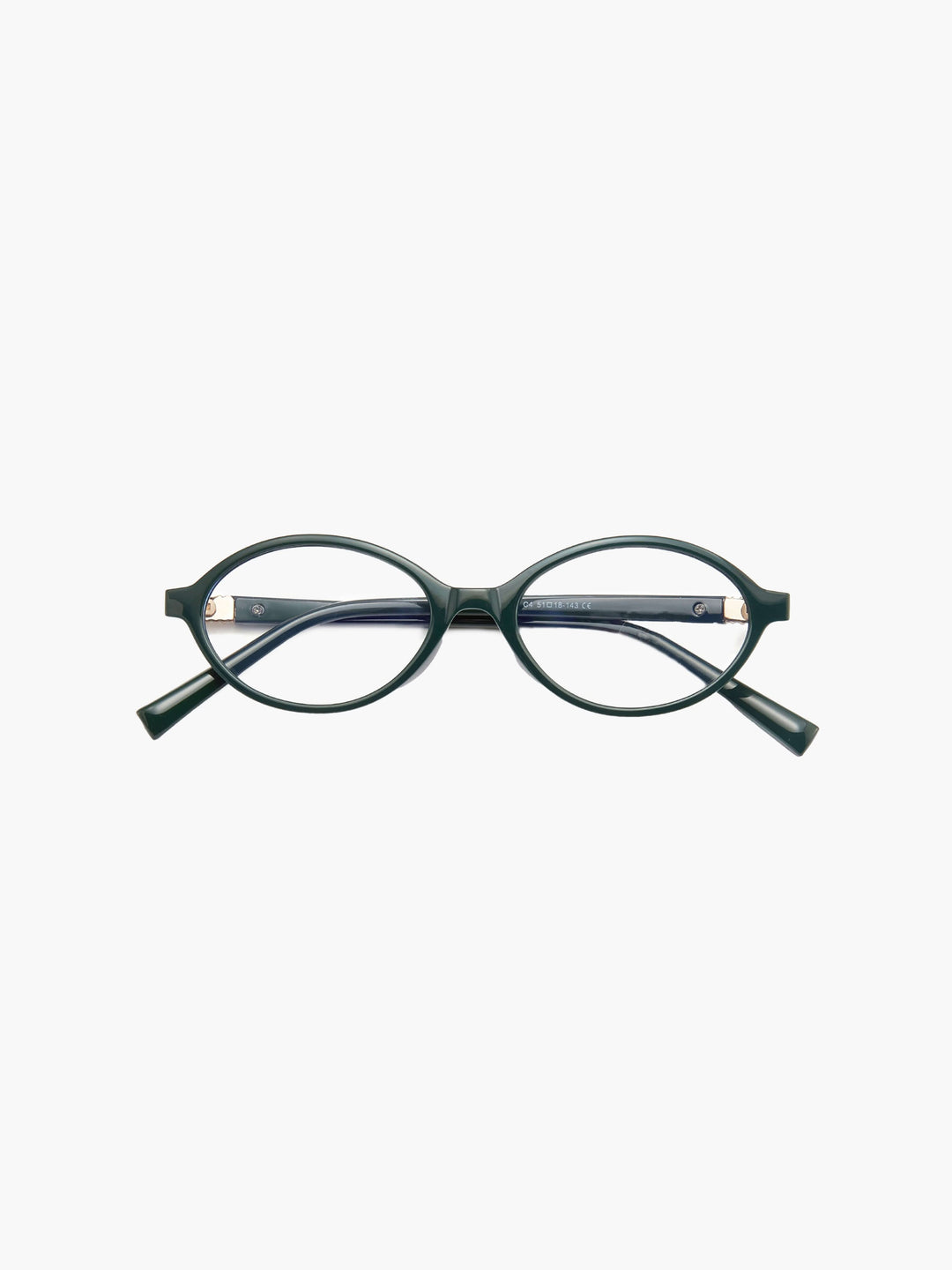 A woman wearing minimalist blue-light reading glasses while relaxing at home.