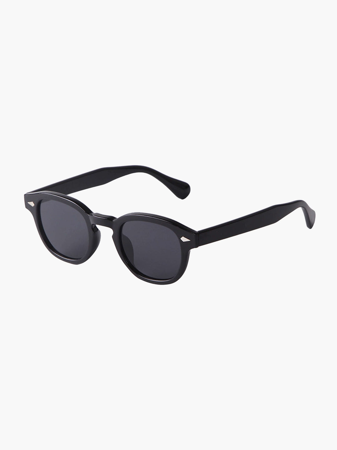 A woman wearing chic round-frame sunglasses on a city walk.