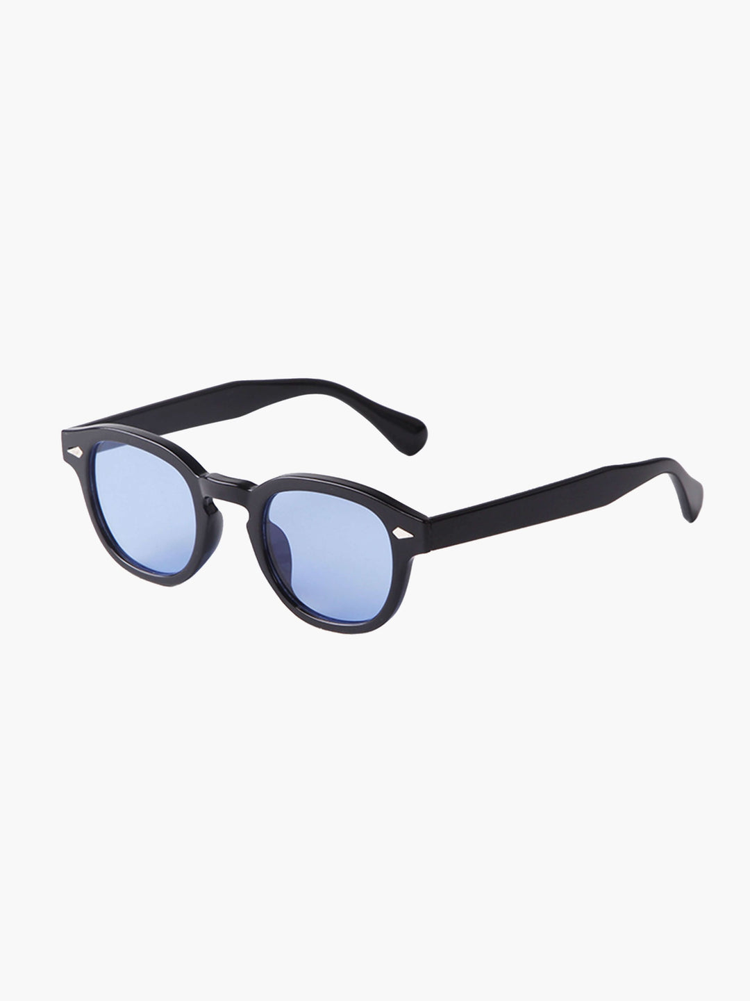 A woman wearing chic round-frame sunglasses on a city walk.