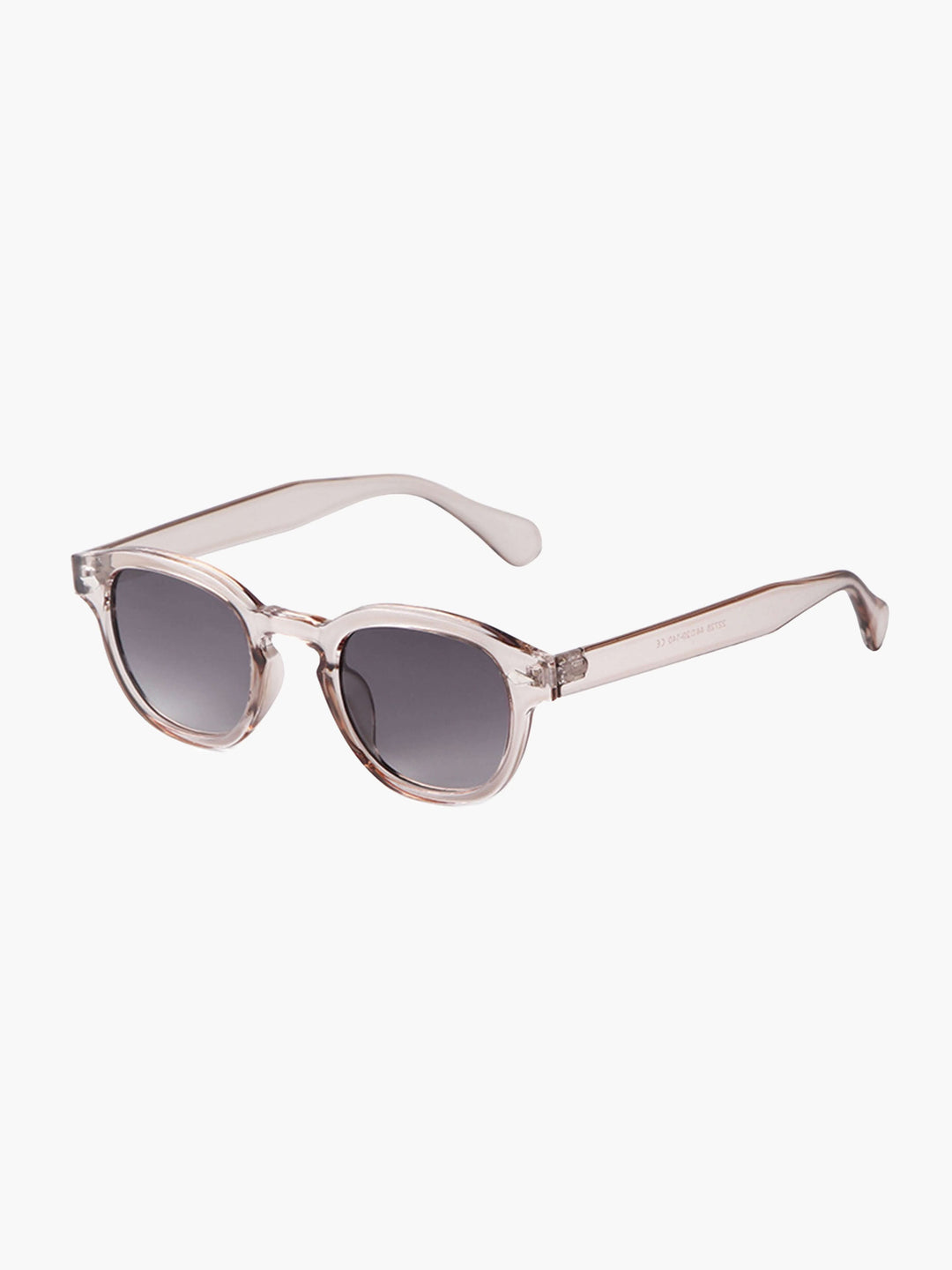 A woman wearing chic round-frame sunglasses on a city walk.