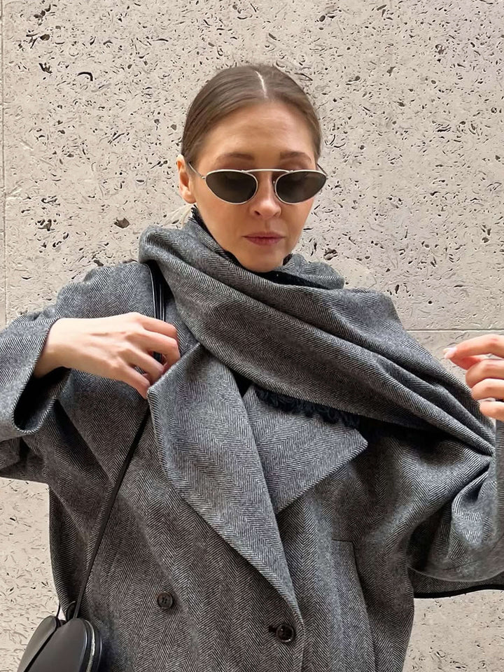 A woman wearing timeless slim black cat-eye sunglasses on an fall day.