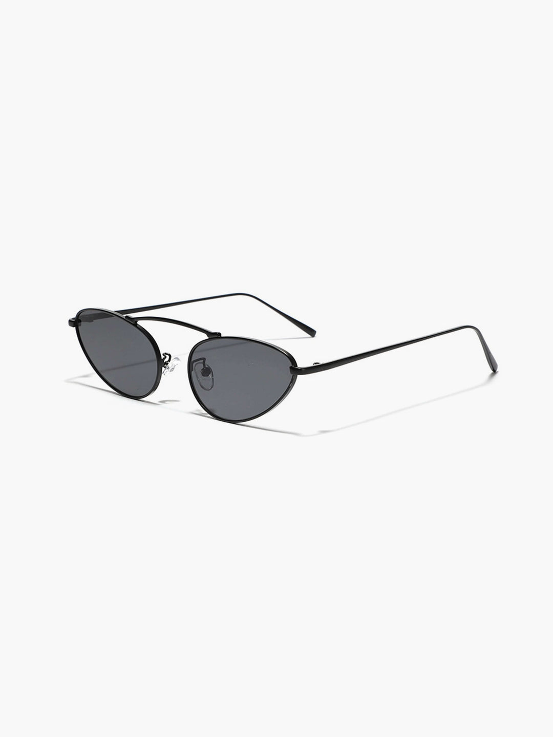 A woman wearing timeless slim black cat-eye sunglasses on an fall day.
