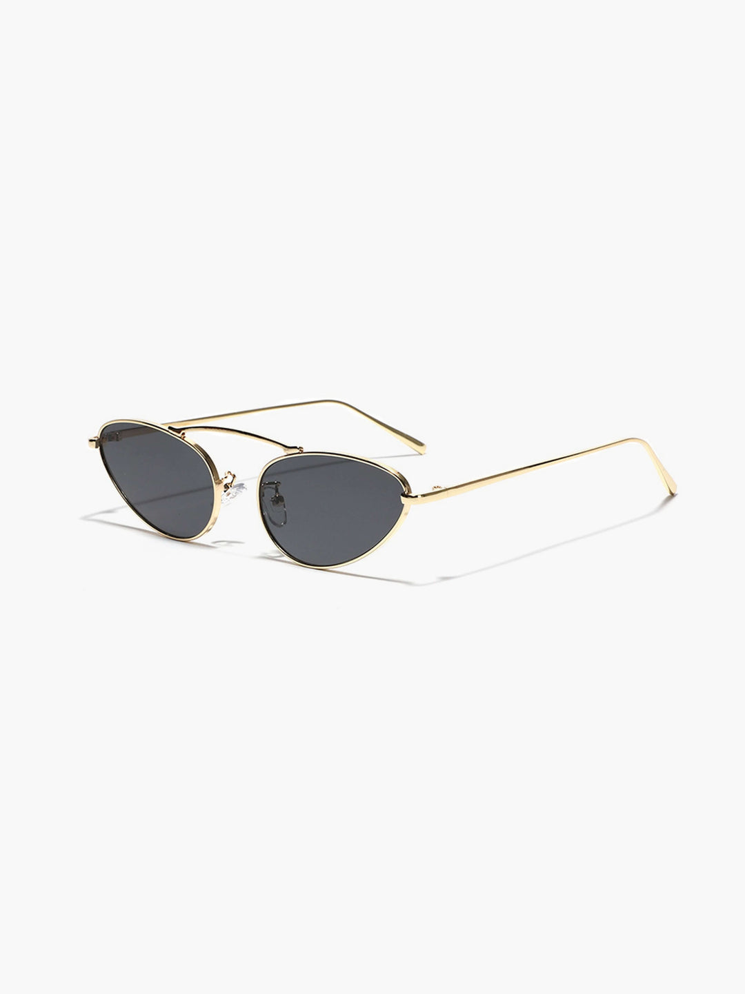 A woman wearing timeless slim black cat-eye sunglasses on an fall day.