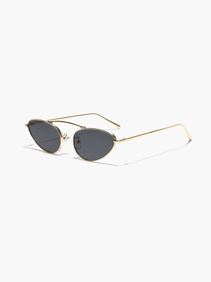A woman wearing timeless slim black cat-eye sunglasses on an fall day.