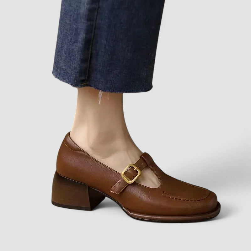 A woman wearing brown T-strap Mary Jane shoes, steady and comfortable through the day.