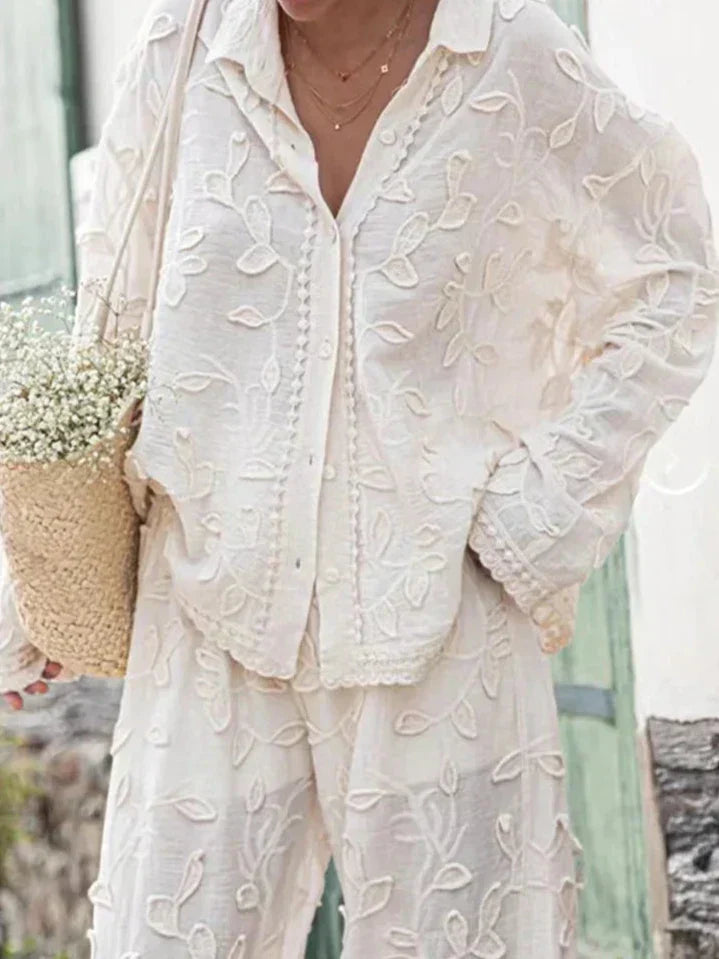 A woman wearing an embroidered relaxed two-piece set with wide pants