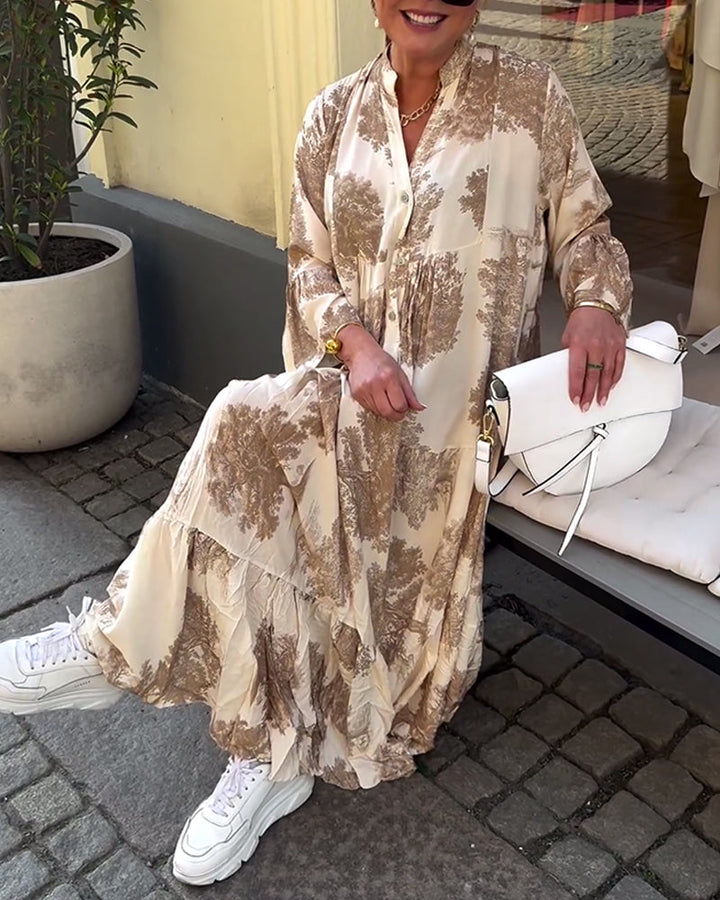 Woman wearing the Sylvie flowing maxi dress with a delicate print and V-neckline, the skirt moving softly as she walks.