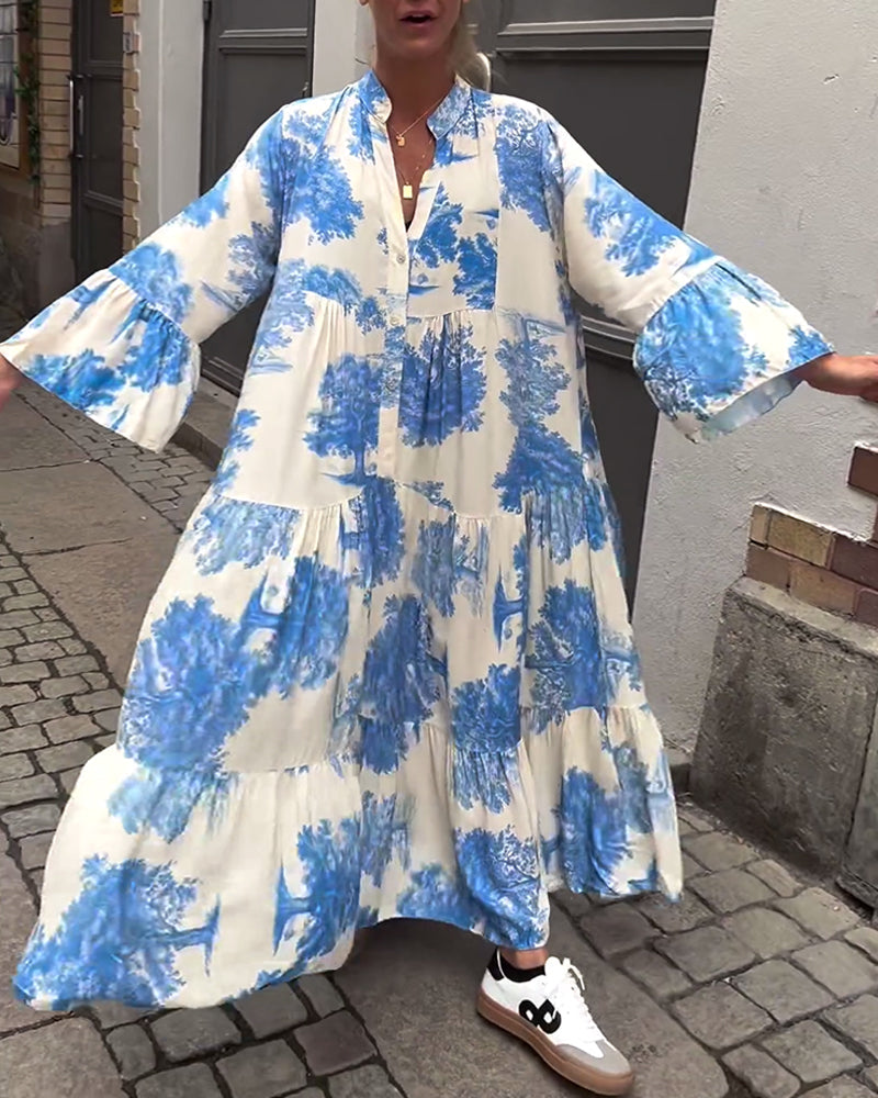 Woman wearing the Sylvie flowing maxi dress with a delicate print and V-neckline, the skirt moving softly as she walks.