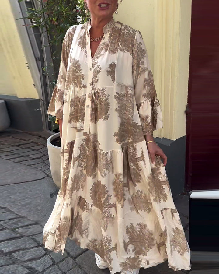 Woman wearing the Sylvie flowing maxi dress with a delicate print and V-neckline, the skirt moving softly as she walks.