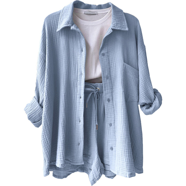 A woman wearing a relaxed button shirt with matching drawstring shorts, fresh and easy.