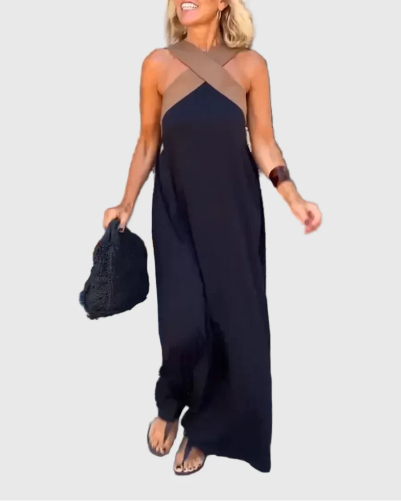 Woman wearing a long flowing maxi dress with a flattering crossover neckline.
