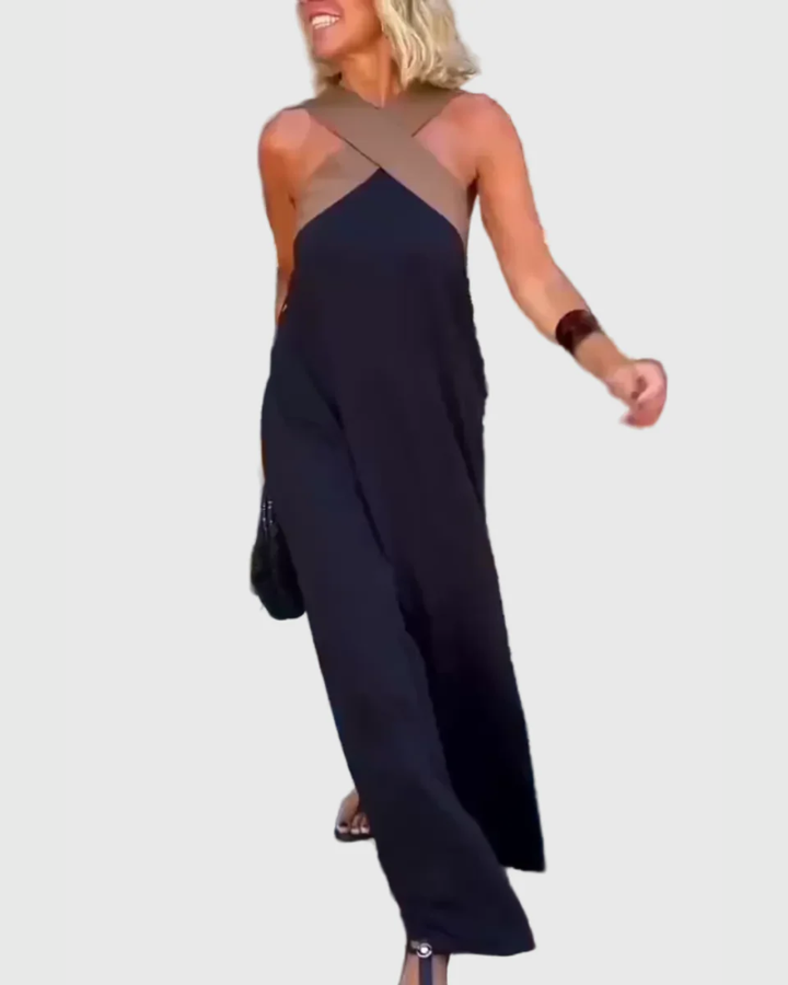 Woman wearing a long flowing maxi dress with a flattering crossover neckline.