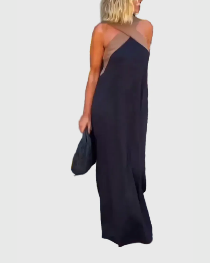 Woman wearing a long flowing maxi dress with a flattering crossover neckline.