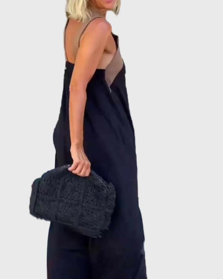 Woman wearing a long flowing maxi dress with a flattering crossover neckline.